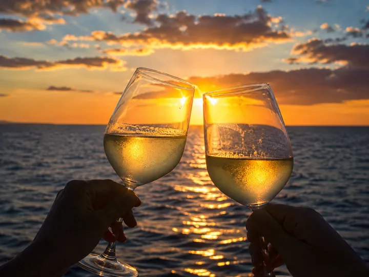 Two glasses overlooking the sea at sunset