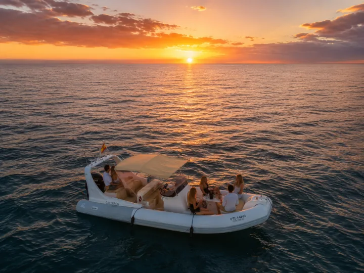 Boat sailing at sunset
